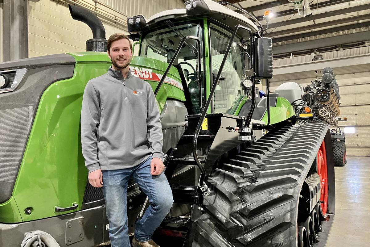 Eric Bossuyt, account manager with AgWest, stands on the steps of a Fendt Vario tractor connected to a Fendt Momentum planter at the dealership in Elie, Man. Photo: Greg Berg
